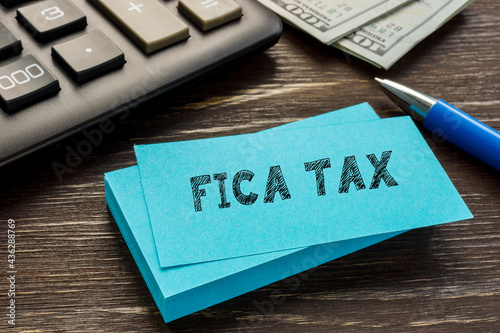 Business concept meaning FICA TAX Federal Insurance Contributions Act with sign on the page.