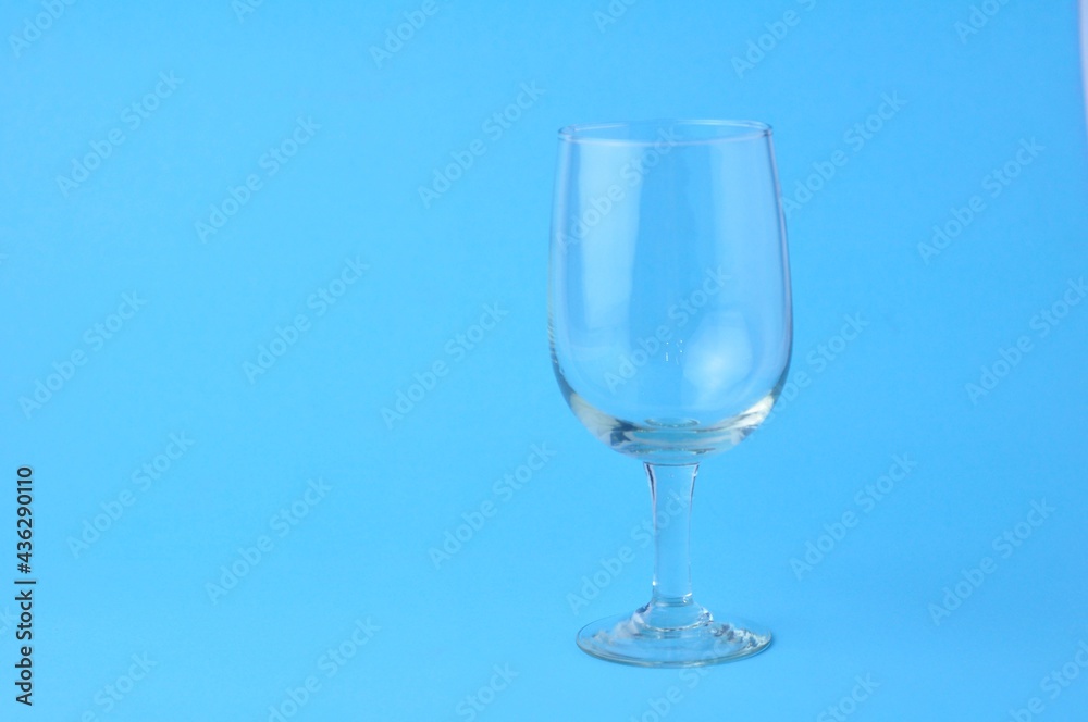 One empty glass isolated on blue background One empty glass isolated on blue background
