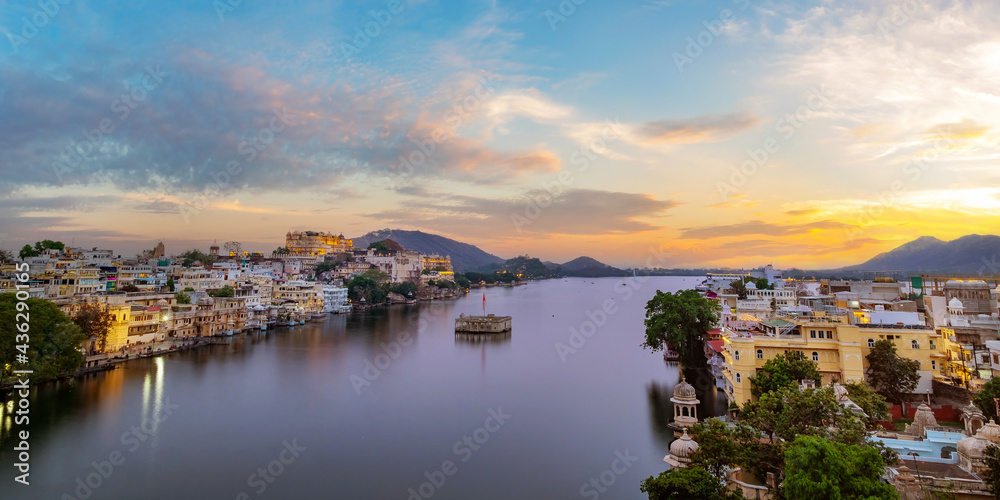Udaipur city at lake Pichola in the evening, Rajasthan, India. View of City palace reflected on the lake.