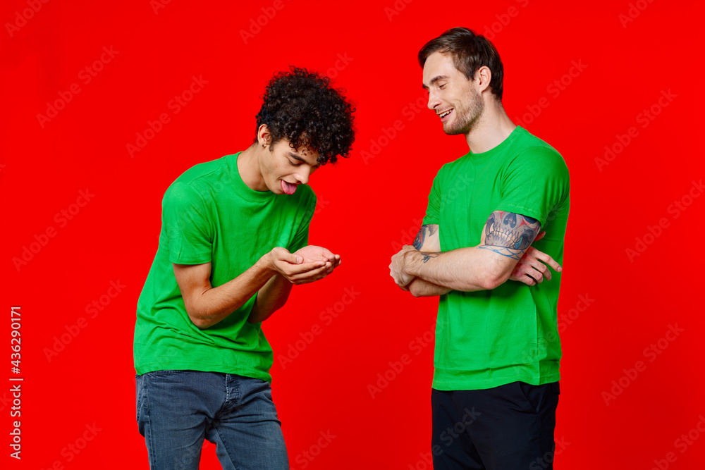 Two man green t-shirts embrace emotions friendship red background Two man green t-shirts embrace emotions friendship red background