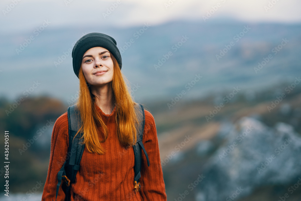 pretty woman tourist with backpack in autumn clothes mountains walk