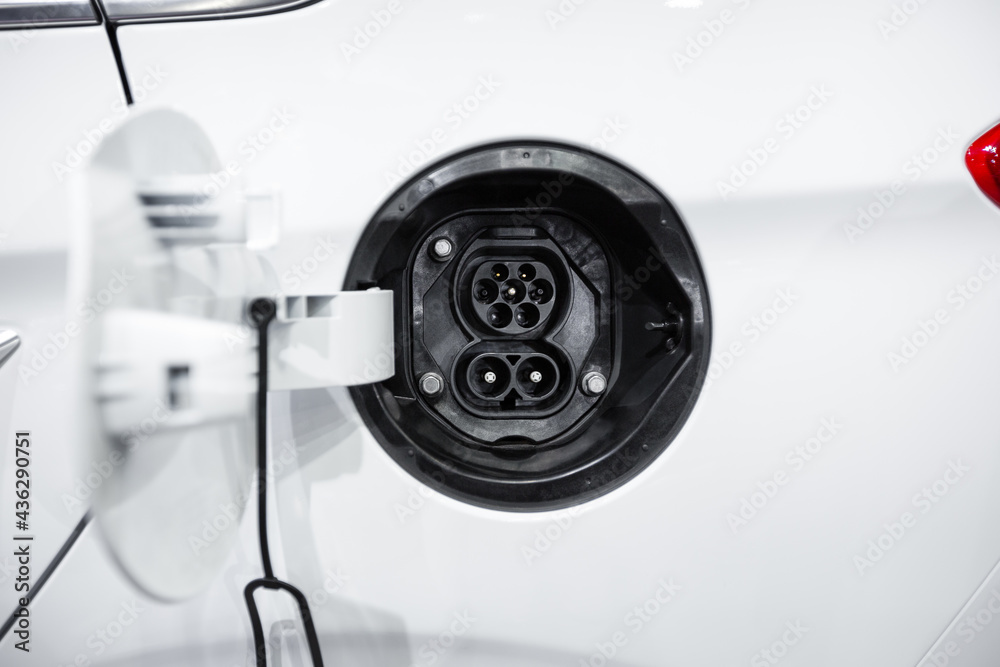 Close-up female electric power plug of white electric car Close-up female electric power plug of white electric car
