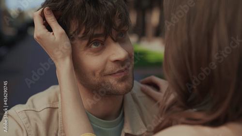 Wallpaper Mural close up of blurred woman adjusting hair of smiling man. Torontodigital.ca
