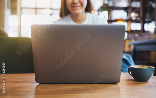 Closeup image of a young woman using and working on laptop computer © Farknot Architect