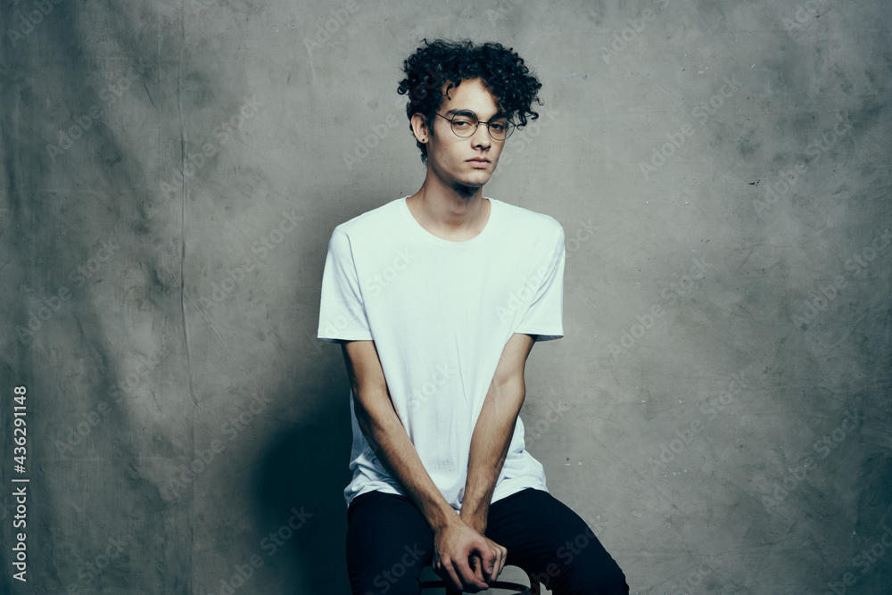 cute guy with curly hair in white t-shirt glasses fashion cute guy with curly hair in white t-shirt glasses fashion