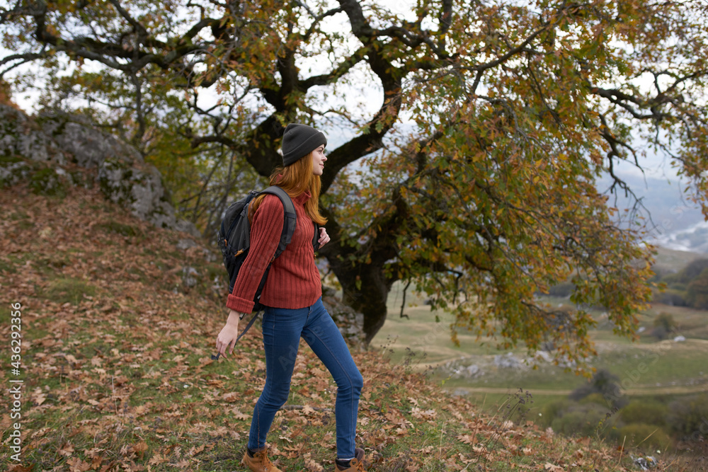 woman tourist with backpack in autumn forest travel nature
