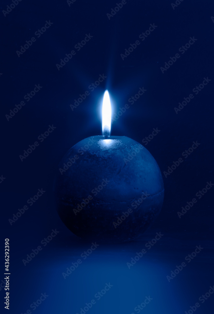 Blue candle light burn isolated black background Blue candle light burn isolated black background