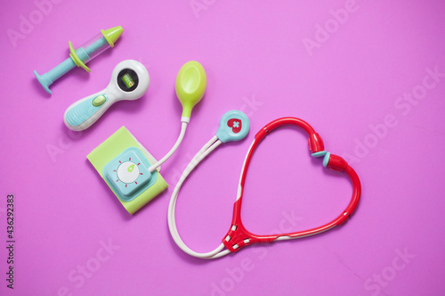 Top view of medical set toys on pink background