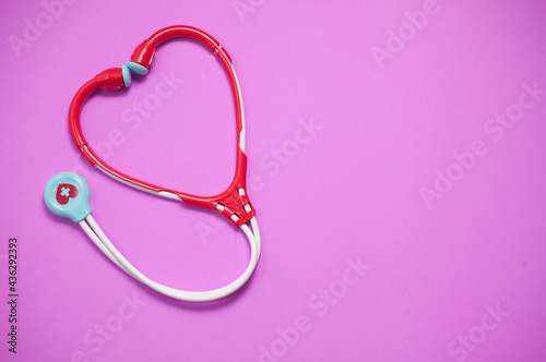 Top view of Stethoscopes toy on pink background