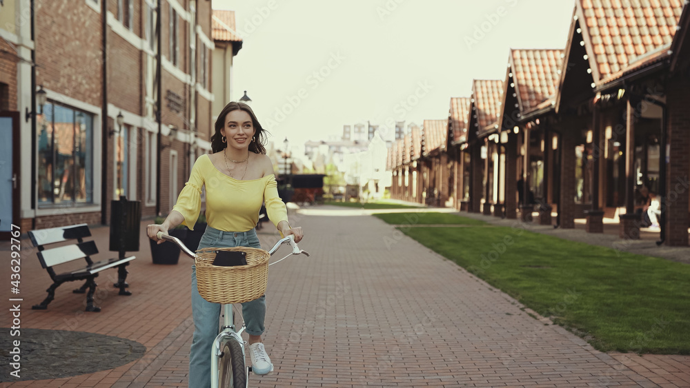 pretty woman riding bicycle on urban street.