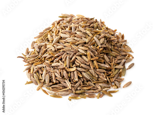 pile of cumin seeds closeup on white