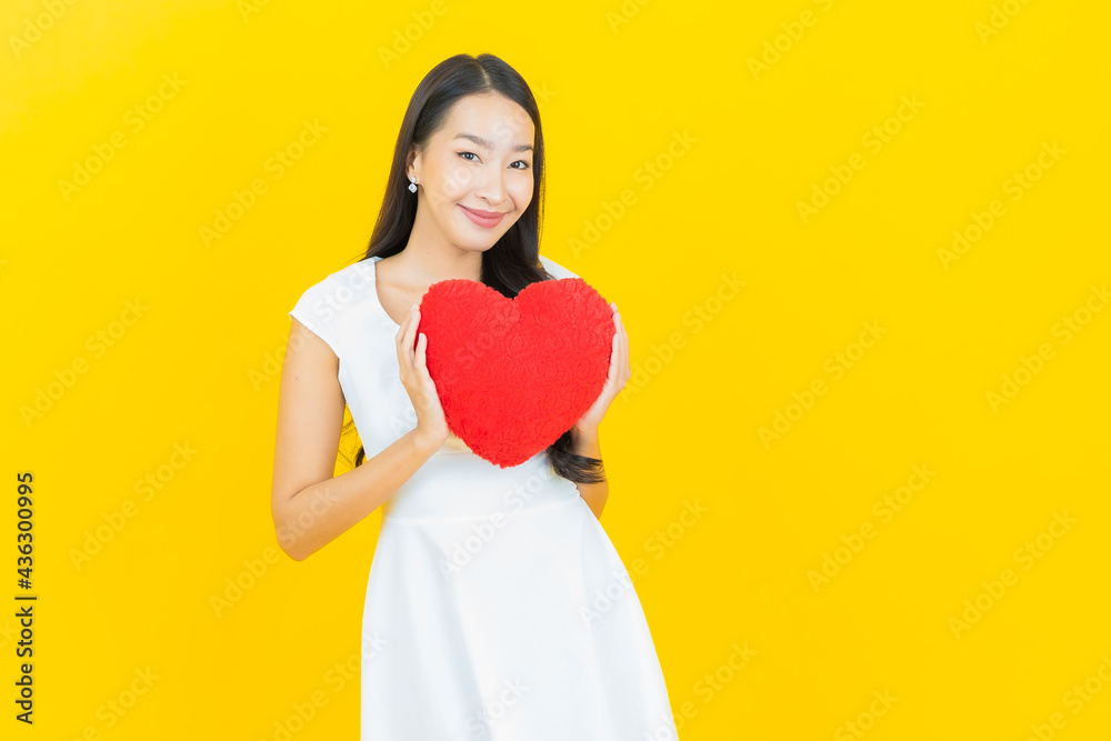 Portrait beautiful young asian woman smile with heart pillow shape Portrait beautiful young asian woman smile with heart pillow shape