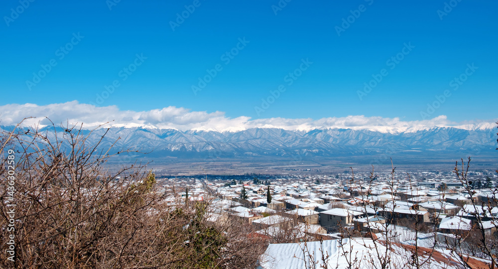 Beautiful view of Caucasus mountains from the town covered with snow