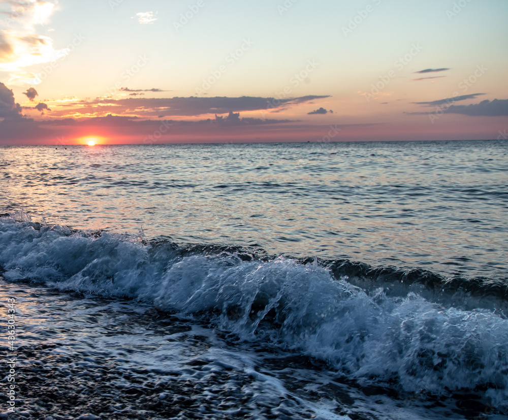 Obraz premium Water by the sea at sunset.