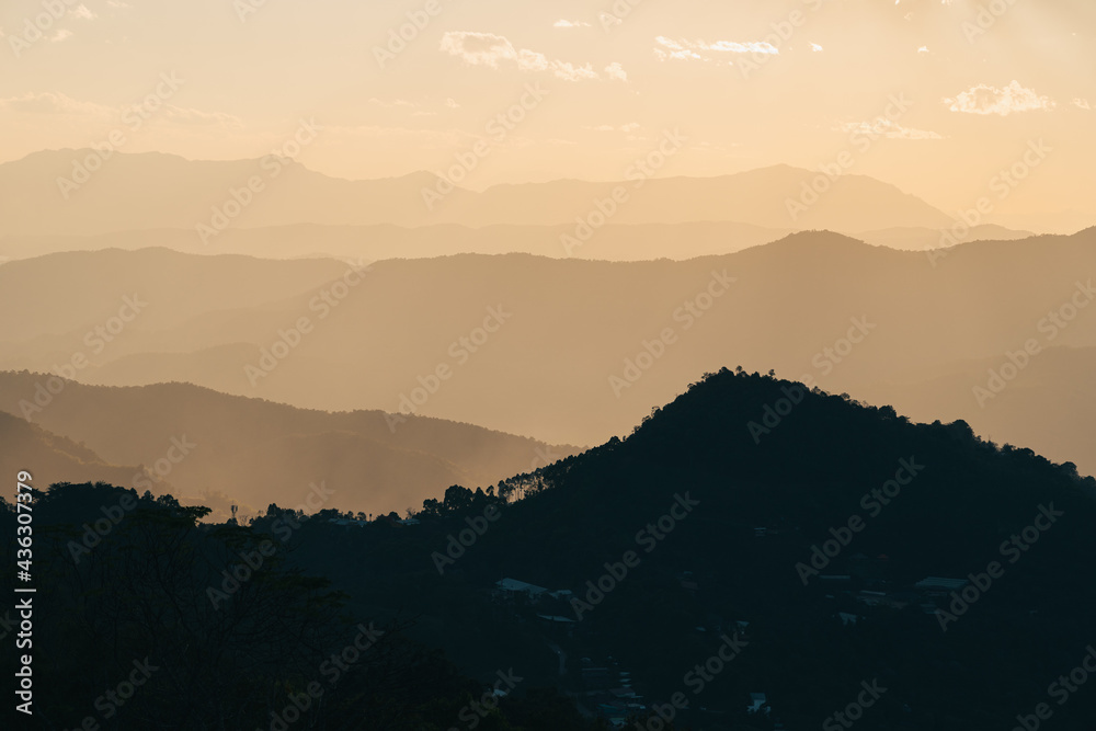 Beautiful mountains layer at sunset in Doi Chang, Chiang Rai province, Thailand