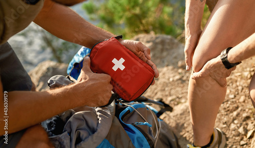 Young caucasian man holding first aid kit for healing