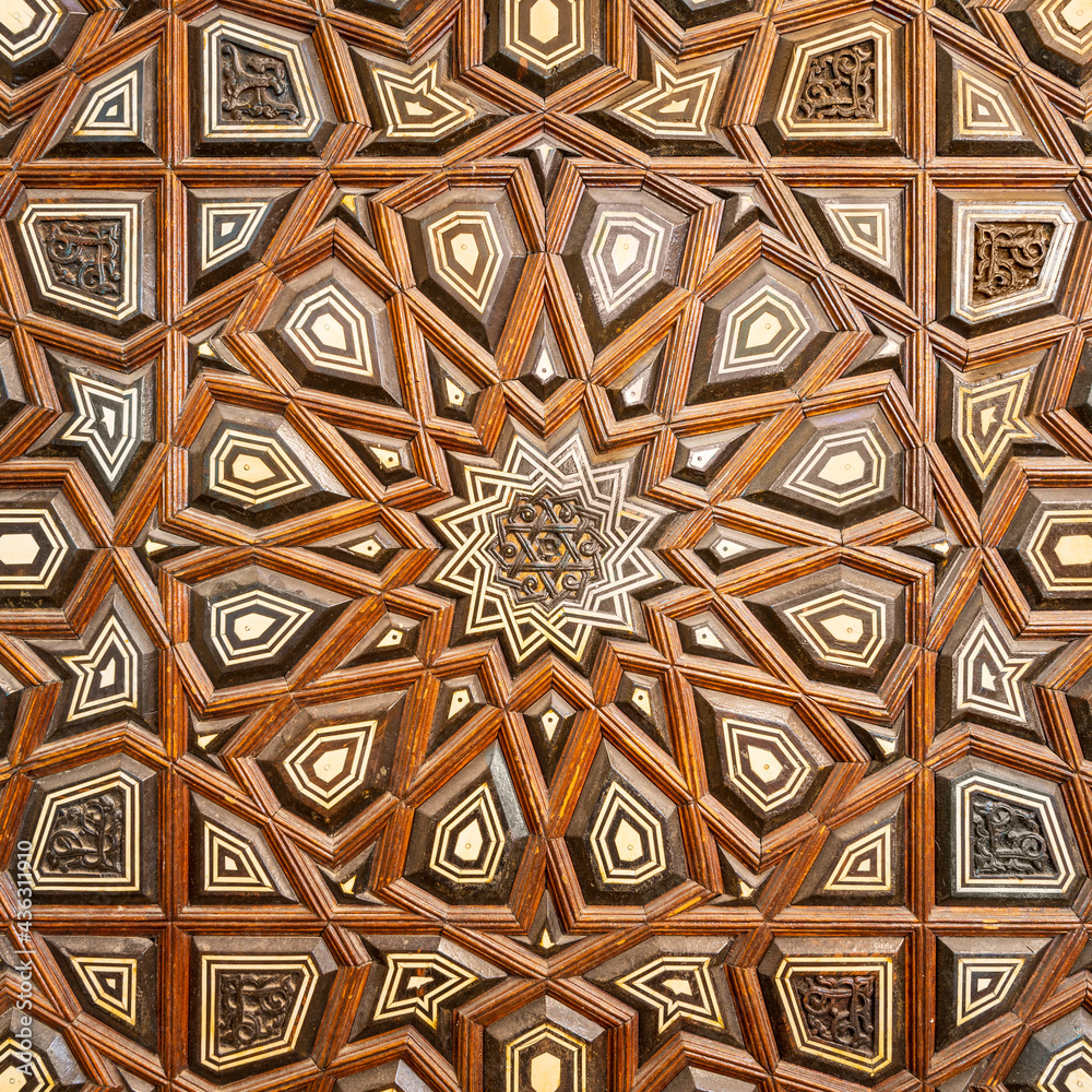 Closeup of wooden arabesque decorations tongue and groove assembled, inlaid with ivory and ebony, on Minbar of Imam Al Shafii public Mosque, Old Cairo, Egypt