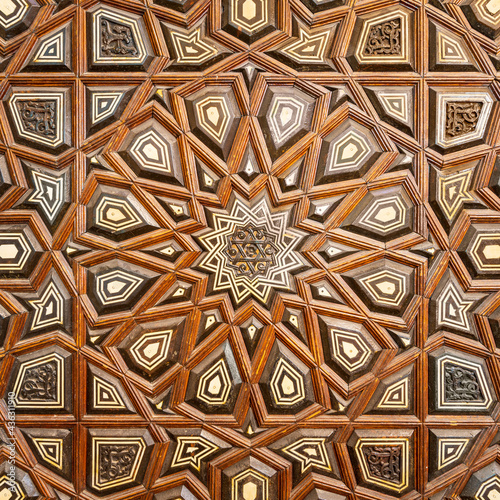 Closeup of wooden arabesque decorations tongue and groove assembled, inlaid with ivory and ebony, on Minbar of Imam Al Shafii public Mosque, Old Cairo, Egypt