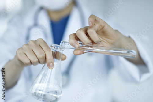 Doctor holding test tube and flask. Biotechnology,medicine,chemistry concept.