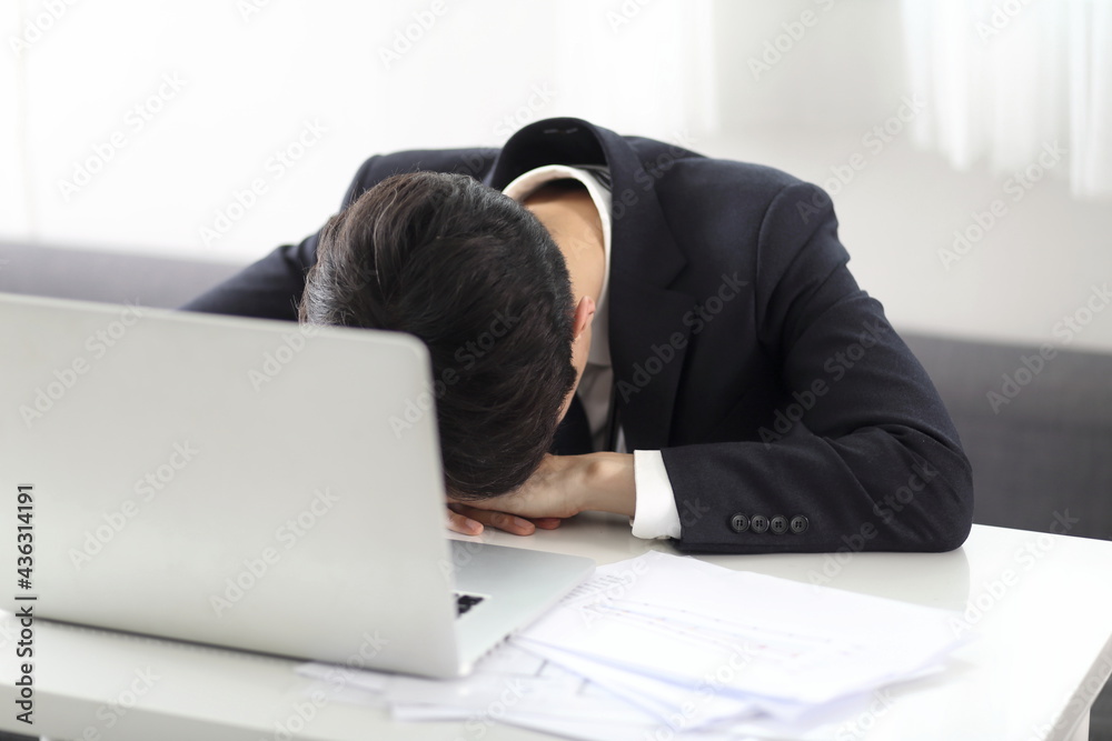 Overworked businessman sleeping on desk Overworked businessman sleeping on desk