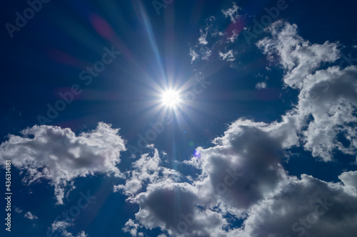 bright daylight sun in blue sky with clouds