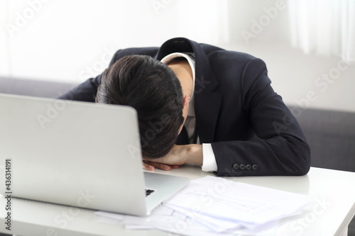 Overworked businessman sleeping on desk