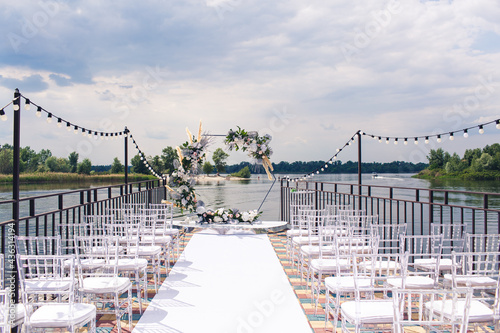 Decoration for a romantic wedding ceremony on the pier by the river