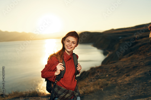 smiling woman hiker with backpack rocky mountains travel