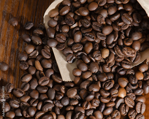 Roasted coffee beans in a paper bag. Close-up. View from above