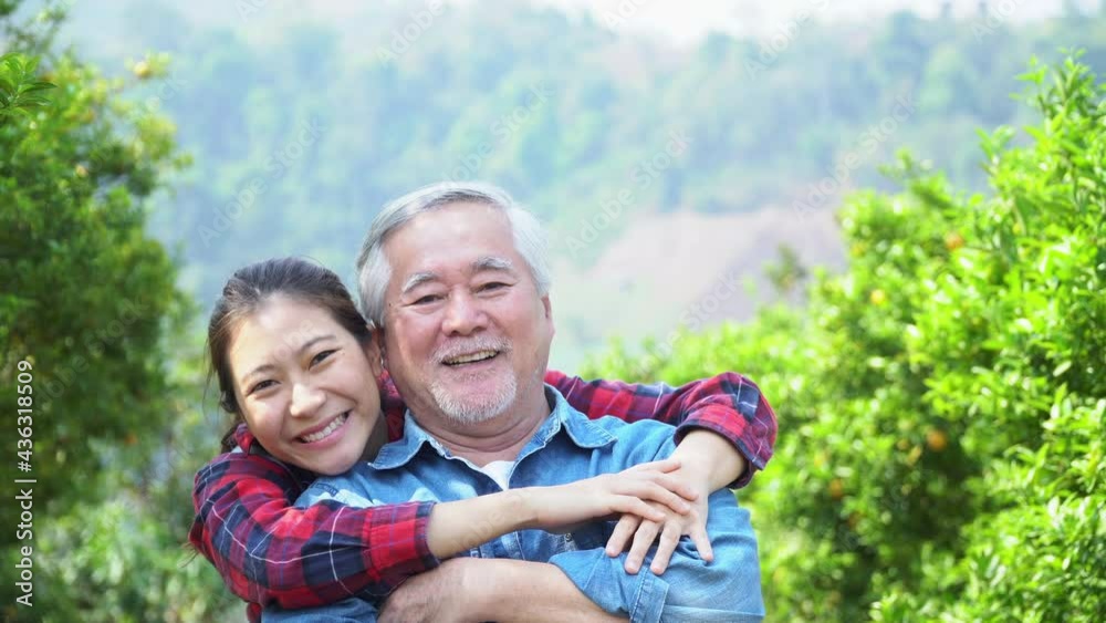 senior man and Young asian woman farmers, happy Farmers Family Agriculture while workingorange tree after harvesting the produce from an orange field.Family business concept
senior man and Young asian woman farmers, happy Farmers Family Agriculture while workingorange tree after harvesting the produce from an orange field.Family business concept