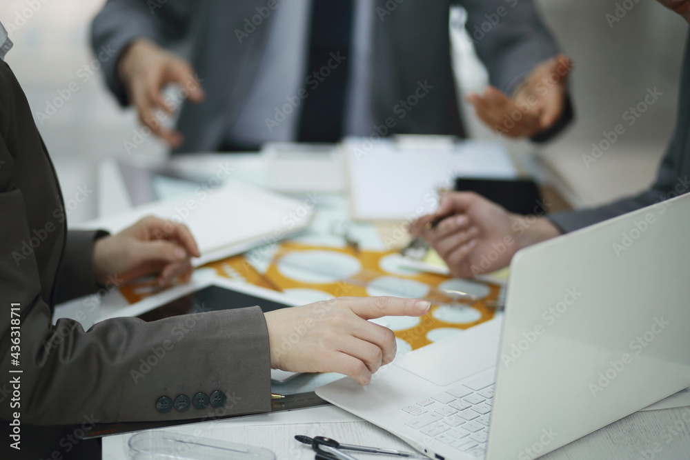 Business people using laptop in meeting