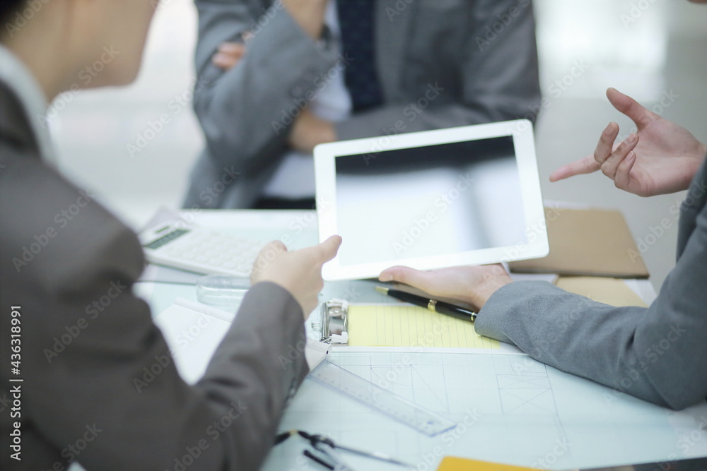 Business people working on digital tablet during meeting Business people working on digital tablet during meeting