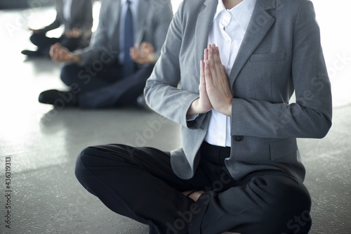 Close up of business people meditating in office