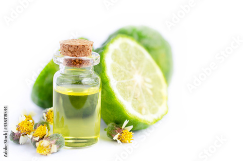 Bergamot fruit extract aroma gel in glass bottle over blur fruit and wil grass flower on white background