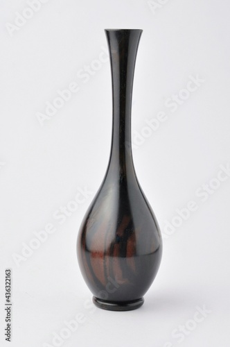 Tall vase for holding flowers in black on a white background.