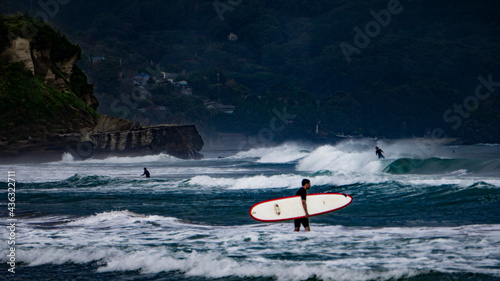 Surfers on a beach of Izu peninsula, Japan photo