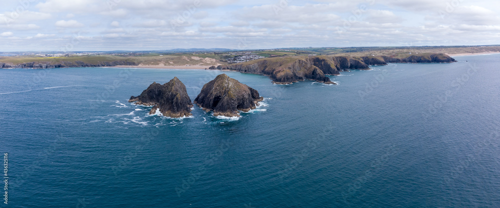 Holywell bay islands also know as gull or carters rocks in cornwall england uk aerial drone