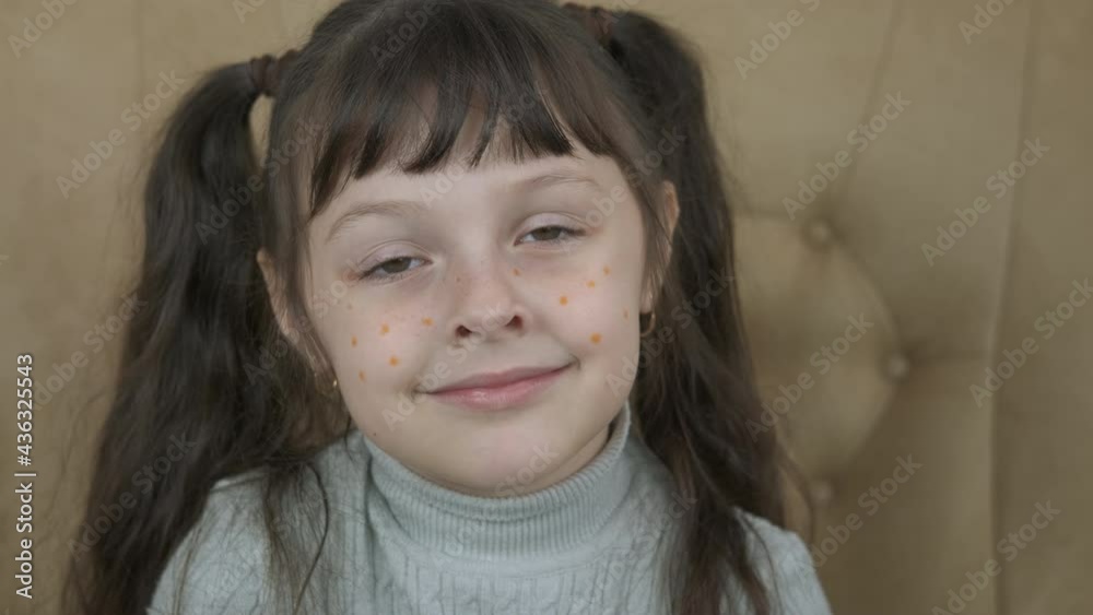 Child with freckles. A happy child with frenkles sits in the armchair in the room. Child with freckles. A happy child with frenkles sits in the armchair in the room.