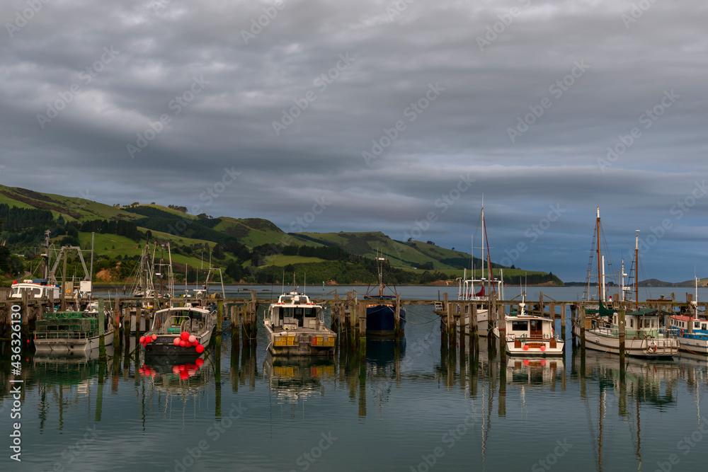 Boats in calm harbour at sunset
