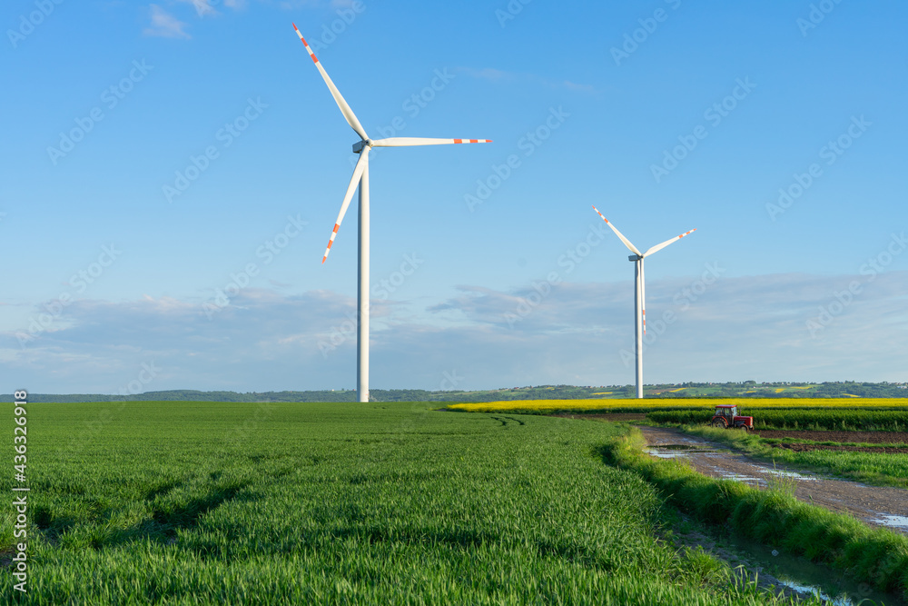 Turbines generate renewable green energy in windmill farm in countryside Turbines generate renewable green energy in windmill farm in countryside