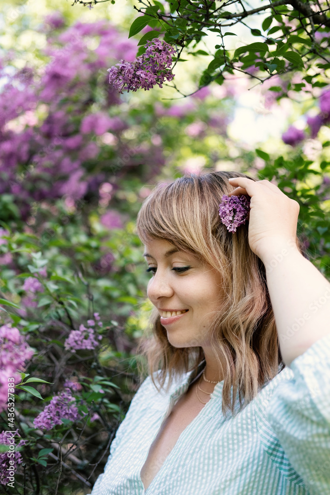 Candid authentic portrait of 30s 40s caucasian blonde woman with lilac flowers. 30 40 year old woman enjoying life in lilac flowers nature background. Reinvention, Life Changes, reinvent yourself Candid authentic portrait of 30s 40s caucasian blonde woman with lilac flowers. 30 40 year old woman enjoying life in lilac flowers nature background. Reinvention, Life Changes, reinvent yourself