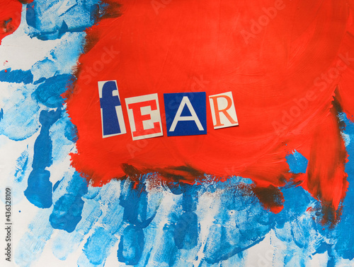 Word writing Fear from cut letters on abstract strokes blue red background. Headline - Fear, card of psychology . Psychologic concept. photo