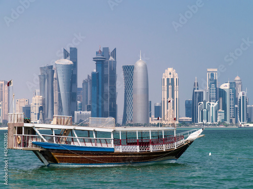 Old dhow against city skyline 