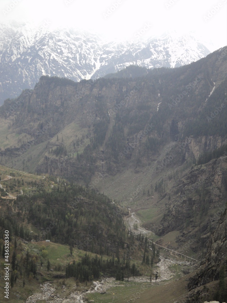 A beautiful and panoramic view of the Himalayan mountains and valleys on the route from Manali to Rohtang Pass.