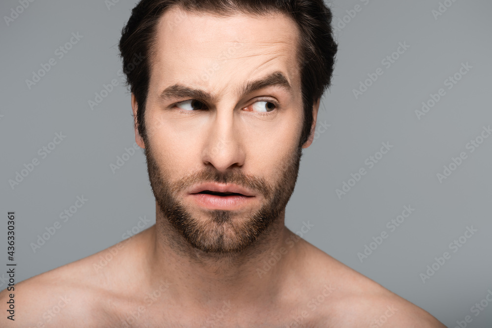 curious and good-looking man looking away isolated on grey. curious and good-looking man looking away isolated on grey.