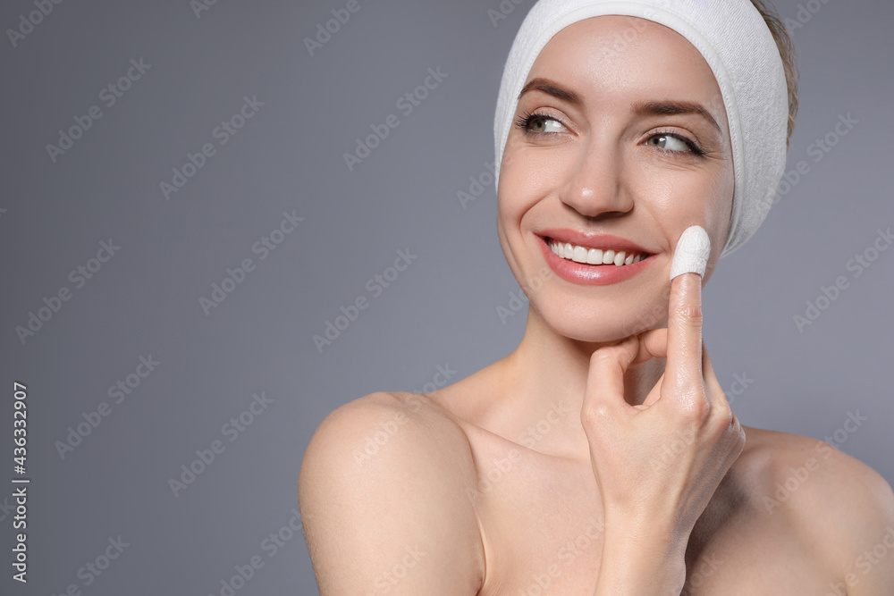 Woman using silkworm cocoon in skin care routine on grey background. Space for text Woman using silkworm cocoon in skin care routine on grey background. Space for text