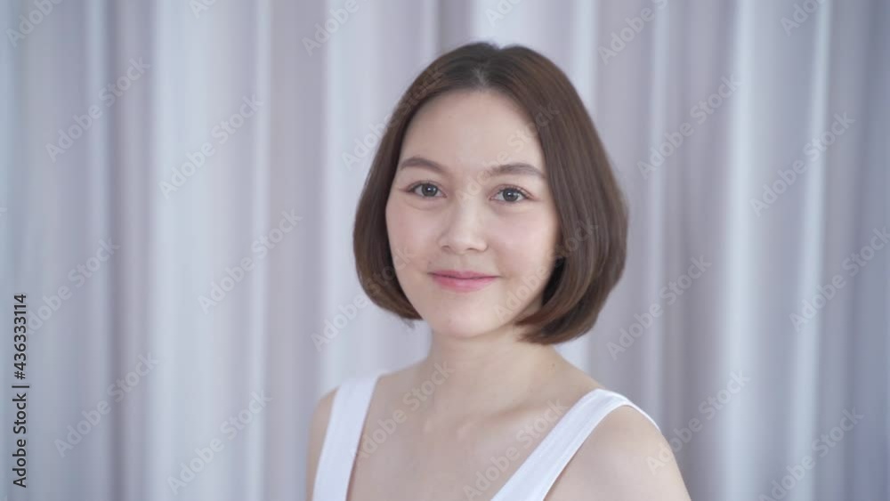 portrait of asian woman short hair in white smiling confidence face expression on background. attractive beautiful female 30's dark brown hair posing for fashion. confident and thinking act. portrait of asian woman short hair in white smiling confidence face expression on background. attractive beautiful female 30's dark brown hair posing for fashion. confident and thinking act.