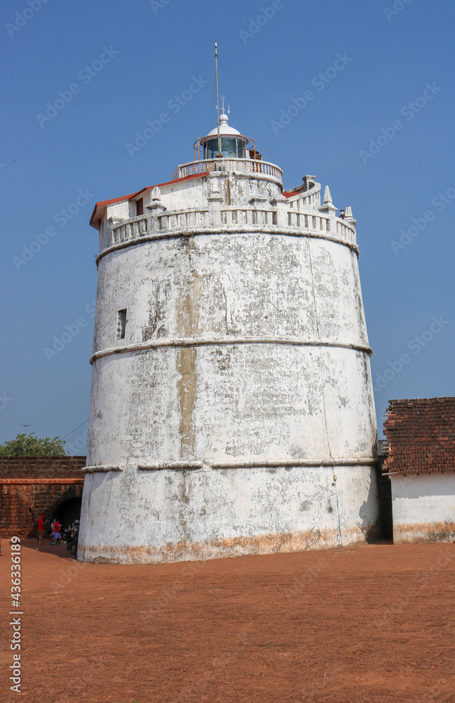 GOA, INDIA - DECEMBER 7, 2019: Fort Aguada is a well-preserved seventeenth-century Portuguese fort, along with a lighthouse, standing in Goa, India, on Sinquerim Beach, overlooking the Arabian Sea.