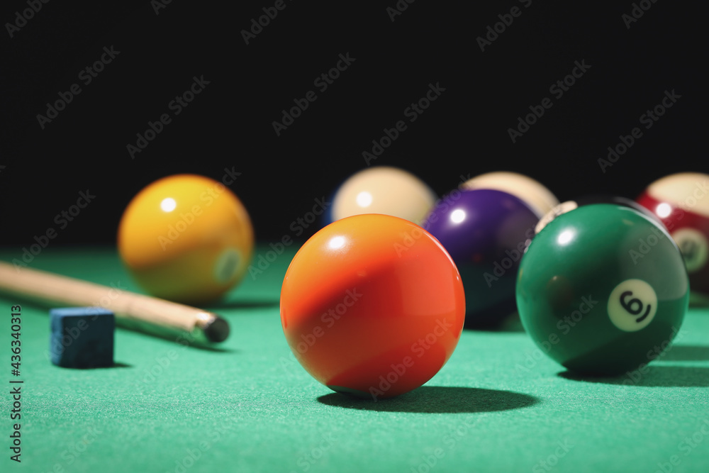 Many colorful billiard balls on green table Many colorful billiard balls on green table