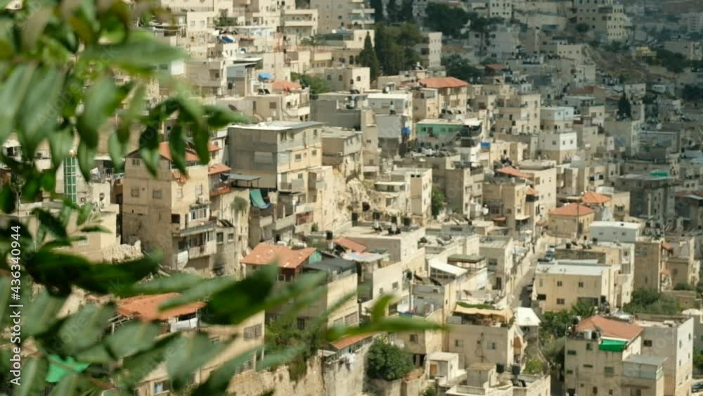 The focus changes beautifully from fresh green leaves to an old village facing the desert in the vicinity of Jerusalem. a 29.97 fps clip, Jerusalem, Israel. The focus changes beautifully from fresh green leaves to an old village facing the desert in the vicinity of Jerusalem. a 29.97 fps clip, Jerusalem, Israel.
